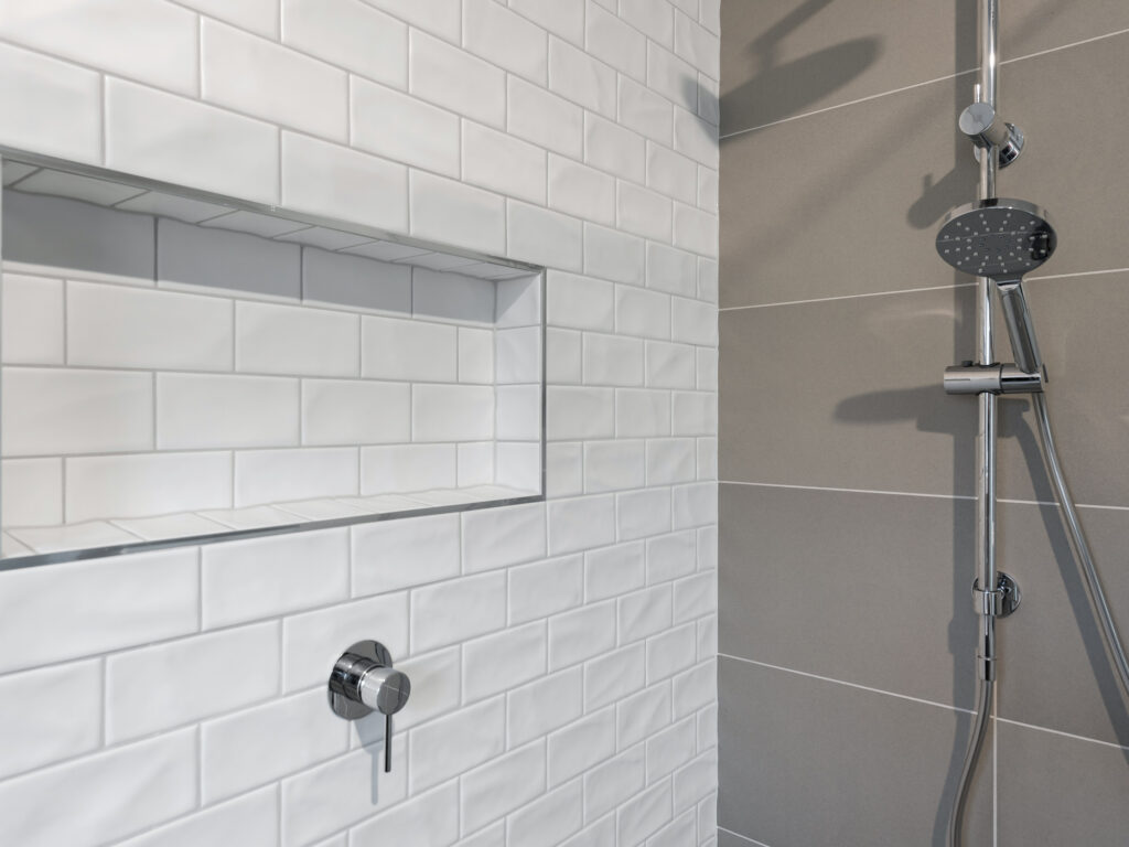 Close-up of glossy black vanity with white framing
