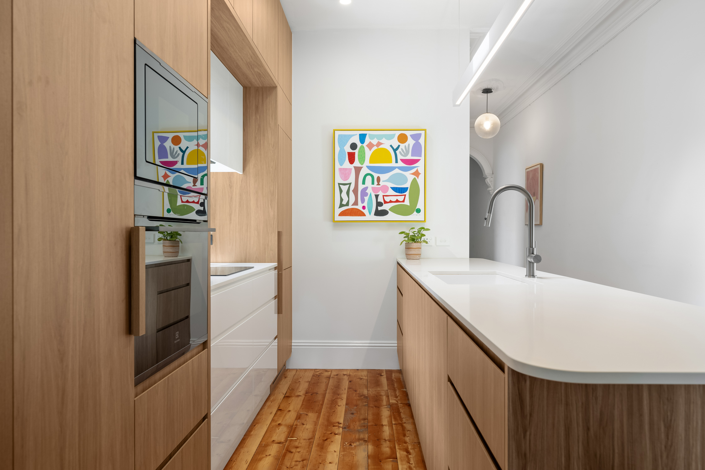Custom cabinetry with integrated appliances in a renovated kitchen
