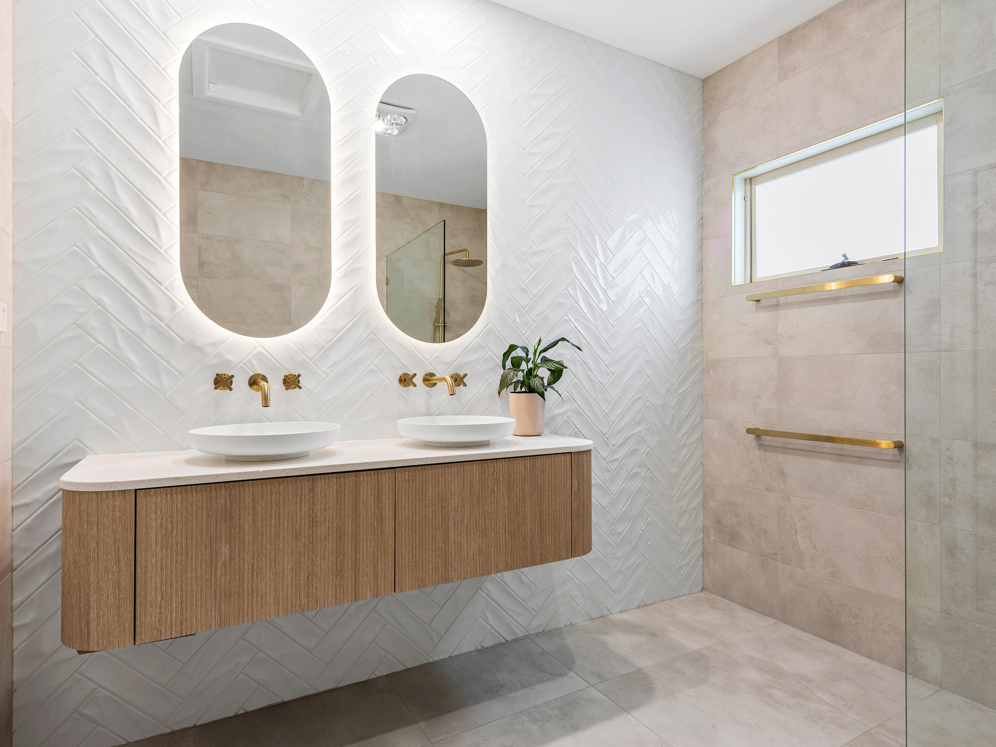 Wide view of renovated bathroom featuring luxury fixtures and natural tones