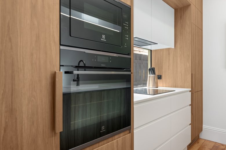 Open-plan kitchen with timber floors and clean lines