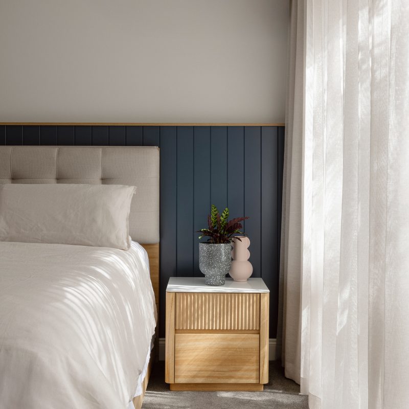 High-end custom vanity with modern basin design and frameless mirror in a contemporary ensuite.